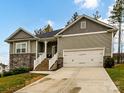 Two-story house with stone accents, two-car garage, and a brick staircase leading to the front porch at 225 Jaida Ln, Oakboro, NC 28129