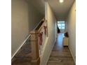 Stairway with wooden railing and holiday decorations, leading to a cozy living room at 3033 Eastcott Ave, Monroe, NC 28110