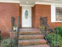 Front entrance with brick steps and iron railings at 4141 David Dr, Matthews, NC 28105