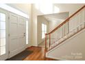 Bright entryway with hardwood floors, staircase, and front door at 1122 Oak Alley Dr, Indian Trail, NC 28079