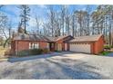 Brick house with attached two-car garage and gravel driveway at 1902 W Sugar Creek Rd, Charlotte, NC 28262