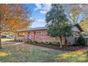 Brick ranch house with mature trees and landscaping at 5001 Currituck Dr, Charlotte, NC 28210