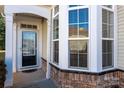 Front entry with black door and bay window at 6327 Cherry Blossom Cir, Indian Land, SC 29707