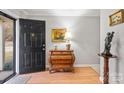 Bright entryway with hardwood floors and a dark wooden console table at 9406 Hinson Dr, Matthews, NC 28105