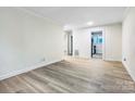 Bright living room with hardwood floors and access to kitchen at 1910 Dickens Ave, Charlotte, NC 28208