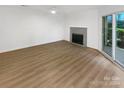 Living room with fireplace and hardwood floors, showcasing natural light at 5003 Sharon Rd # S, Charlotte, NC 28210