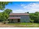 Gray house with red roof, porch, and trees nearby at 5621 Mount Olive Church Rd, Charlotte, NC 28278