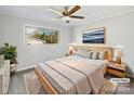 Virtually staged bedroom with wood bed frame and neutral color palette at 104 Abingdon Cir, Huntersville, NC 28078