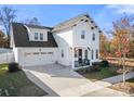 Two-story white house with a gray roof and a two-car garage at 12502 Stonebriar Ridge Dr, Davidson, NC 28036