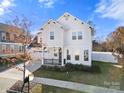 Two-story white house with a gray roof, two-car garage, and landscaping at 12502 Stonebriar Ridge Dr, Davidson, NC 28036