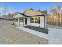 White house with black accents, front porch, and landscaped yard at 1316 Carmel Rd, Lancaster, SC 29720