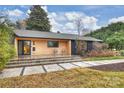 Modern front porch with concrete steps, wood siding, and black metal chairs at 1823 Bentley Pl, Charlotte, NC 28205