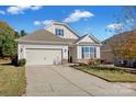 Tan house with a two-car garage and manicured lawn at 3657 Norman View Dr, Sherrills Ford, NC 28673