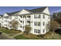 Exterior view of a three-story building with light-colored siding and multiple windows at 3867 Carl Parmer Dr, Harrisburg, NC 28075