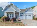 Lovely ranch-style home featuring a two-car garage and welcoming landscaping at 685 Goldflower Dr, Rock Hill, SC 29732