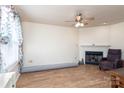 Cozy living room with a fireplace, ceiling fan, and wood-look tile floors at 1096 22Nd Ne St, Hickory, NC 28601