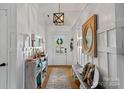 Welcoming entryway with a bench and large mirror at 12128 Robins Nest Ln, Charlotte, NC 28269