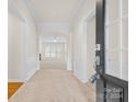 Bright entryway with tile flooring and view into the living room at 15331 Legend Oaks Ct, Fort Mill, SC 29707