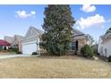 Gray siding ranch home with a magnolia tree in the front yard at 15331 Legend Oaks Ct, Fort Mill, SC 29707