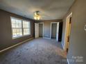 Spacious bedroom with carpeted floor, double closets, and a ceiling fan at 2308 Grayson Pkwy, Monroe, NC 28110