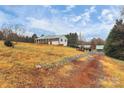 Ranch style home on a hill with a long driveway and a flag at 2945 Parks Lafferty Rd, Concord, NC 28025