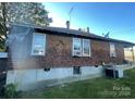 Rear view of the house highlighting the wood siding and additional yard space at 50 Ranlo Ave, Gastonia, NC 28054