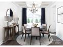 Elegant dining room with round table, chandelier, and dark wood accents at 89 Belwood Dr # 75, Belmont, NC 28012