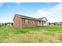 Brick house side view, showcasing a large backyard at 102 Caribou Dr, Statesville, NC 28625