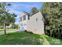 Gray sided two story house with a white garage door at 2225 Southwind Dr, Charlotte, NC 28216