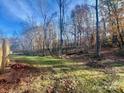 Wooded backyard with a partially visible deck and grass at 46 Kidd And Brown Rd, Hiddenite, NC 28636