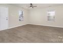 Spacious living room featuring wood-look floors and ceiling fan at 517 Pullman Sw St, Concord, NC 28025