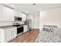 Modern kitchen featuring white cabinets, granite countertops, and stainless steel appliances at 642 Lamorak Pl, Richburg, SC 29729