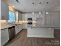 Modern kitchen with white cabinets, granite countertops, and stainless steel appliances at 2008 Laurel Village Cir, Belmont, NC 28012