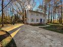 Gray house with blue door, surrounded by trees and a paved driveway at 2117 Arden Dr, Monroe, NC 28112