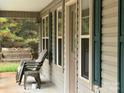 Relaxing front porch with seating and a swing at 369 Pinecrest Cir, Troy, NC 27371