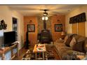 Living room with stone fireplace and wood accents at 369 Pinecrest Cir, Troy, NC 27371