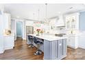 Modern kitchen with white cabinets, a large island, and stainless steel appliances at 5164 Green Rd, Stanley, NC 28164
