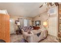 Living room with two sofas, a wooden cabinet, and a stone accent wall at 8112 Pine Lake Rd, Denver, NC 28037