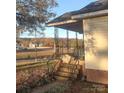 View of home's side and porch with distant view of other houses at 9414 Oak Grove Rd, Stanfield, NC 28163