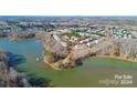 Townhome situated on a lakefront community with surrounding houses and water at 4146 La Crema Dr, Charlotte, NC 28214