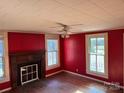 Living room featuring hardwood floors, fireplace, and red walls at 4220 Woodleaf Rd, Salisbury, NC 28147