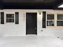 Contemporary black front door accented with black shutters at 5674 Alan D Good Ln, Conover, NC 28613