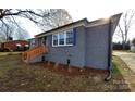 Side view of the house showing a freshly painted exterior and landscaping at 908 E Main St, Maiden, NC 28650