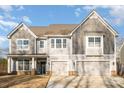 Two-story home with gray siding, three-car garage, and a landscaped yard at 9140 Cantrell Way, Huntersville, NC 28078