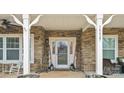 Inviting front door entrance with stone exterior and porch at 10827 Hadrians Walk Ct, Mint Hill, NC 28227