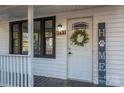 Front door entry to a charming white house at 143 Hallman St, Cherryville, NC 28021