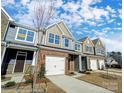 Row of townhomes with brick fronts and attached garages at 4263 Black Ct # 201, Harrisburg, NC 28075