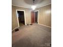 Quaint dining area with wood paneled walls and carpet at 601 Sherman St, Badin, NC 28009