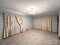 Bright living room featuring light walls and carpeted floor at 601 Sherman St, Badin, NC 28009