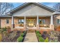 The inviting front porch offers a comfortable seating area and a bright yellow door at 1115 Stony Point Rd, Kings Mountain, NC 28086